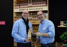 Frederik de Koning en Jaap van Pijkeren bij de kast vol biologische sapjes van Schulp Vruchtensappen.