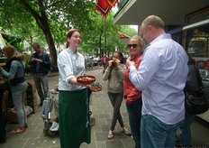 Maaike Nolters liet bezoekers proeven van biologisch vlees, hier heeft ze frikandellen en spareribs vast.